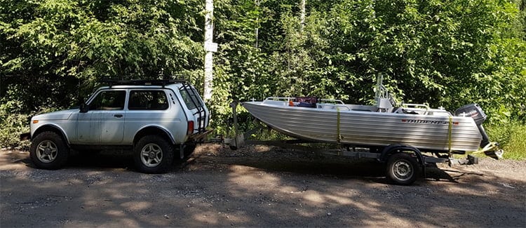 car carries motorboat on a trailer