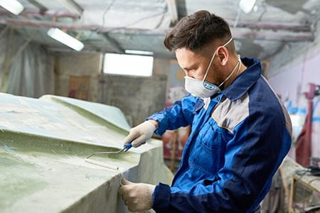 man repairing boat